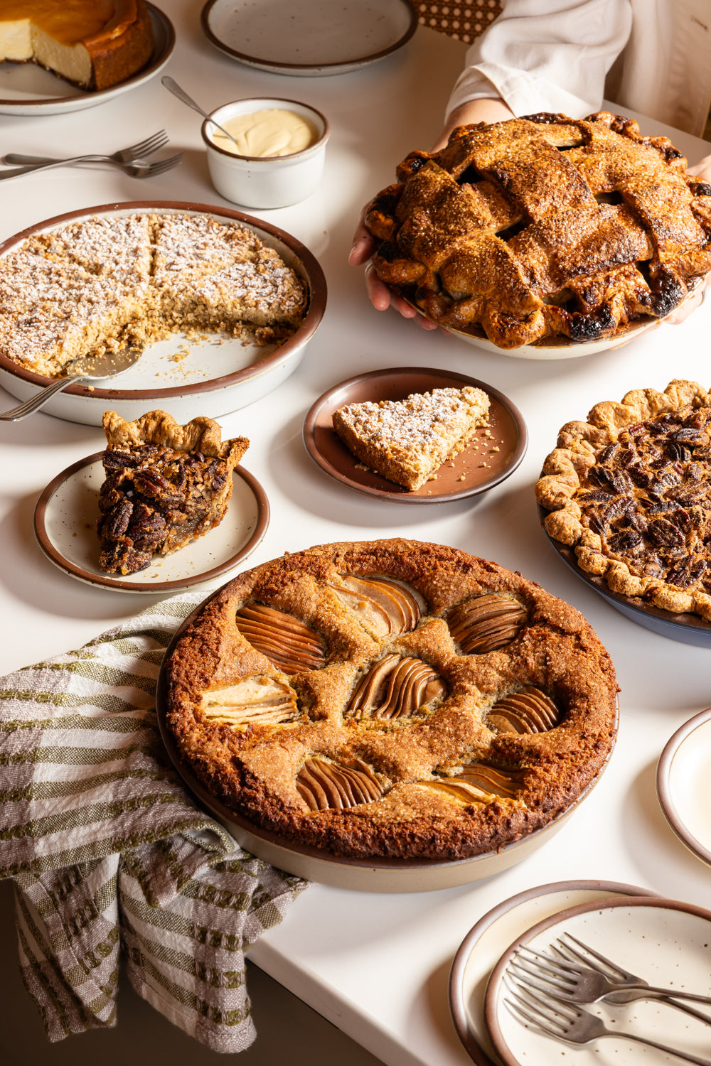 Pies and tarts spread out on a countertop