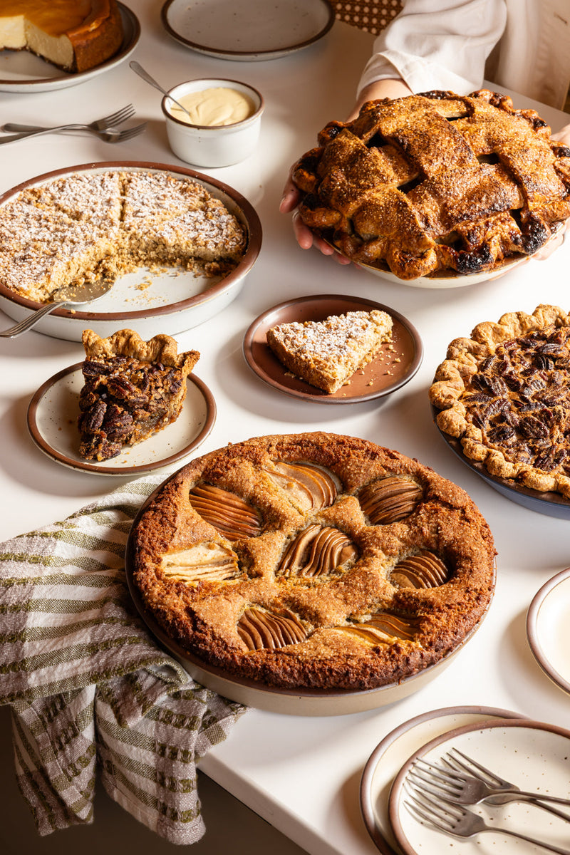 Pies and tarts spread out on a countertop