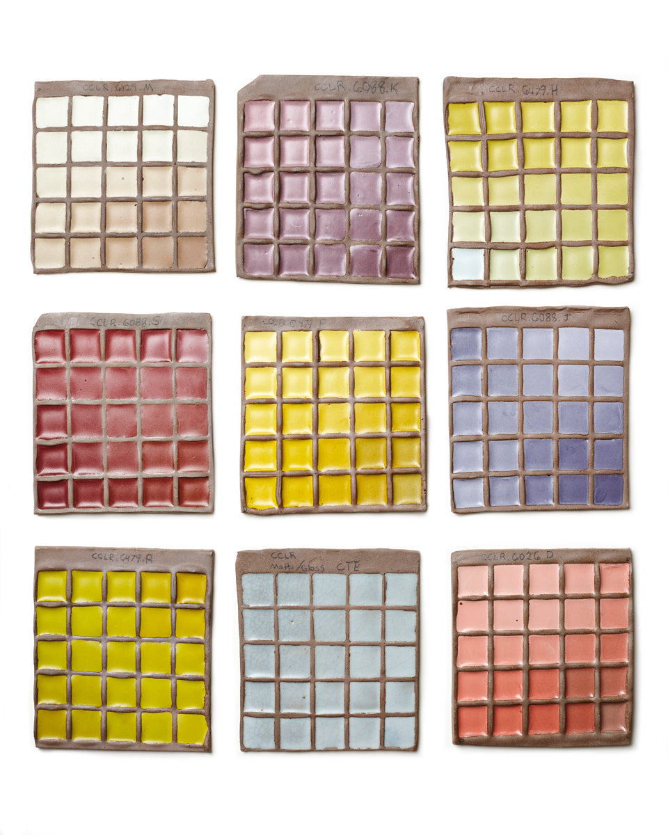 Nine square tiles with grid patterns in various colors on a white background