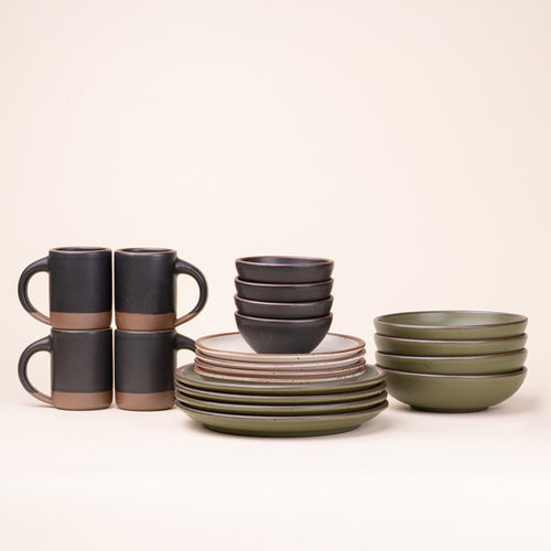 A 20-piece set of ceramic tableware, including mugs, bowls, and plates in a warm off-white, black graphite, and olive green colors.
