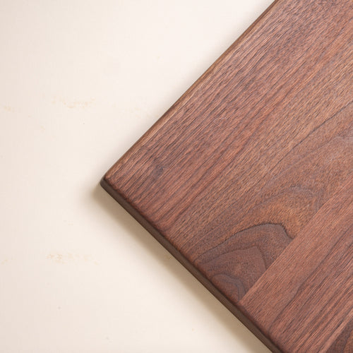 Closeup of a corner of a rectangular walnut cutting board