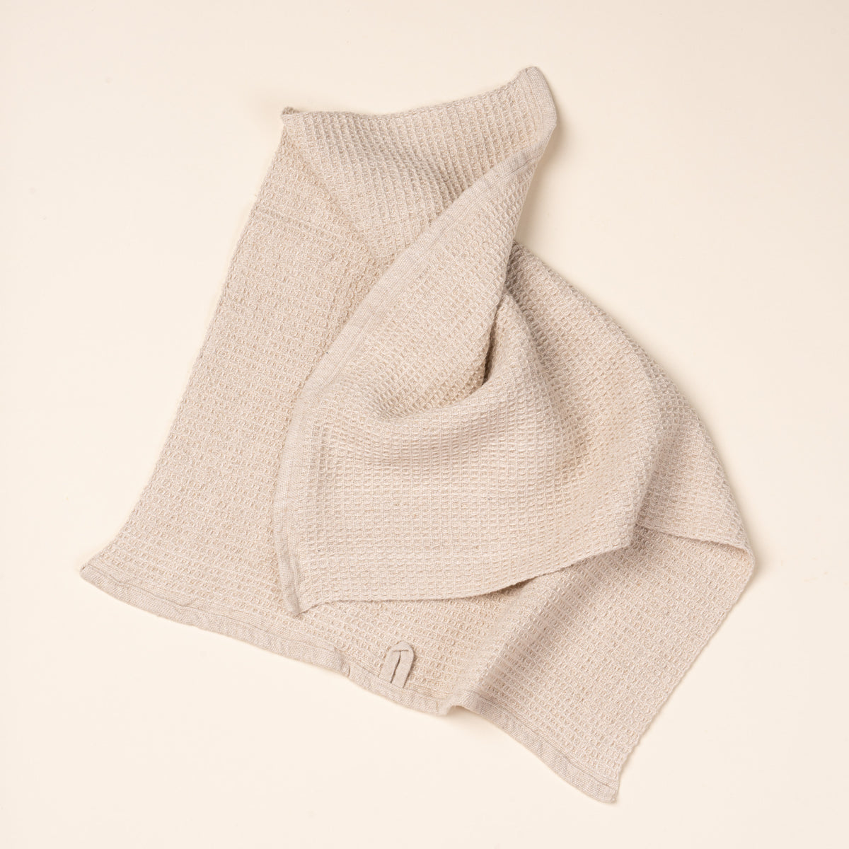 A natural waffle weave kitchen towel