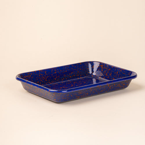 Large rectangular baking dish in a midnight blue color with red splatter pattern.