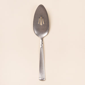 Vintage-inspired silver pie server with a slotted blade and fluted handle.