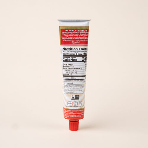 Back view of a tube of Mutti double concentrated tomato paste showing nutrition facts, ingredients, and product information.