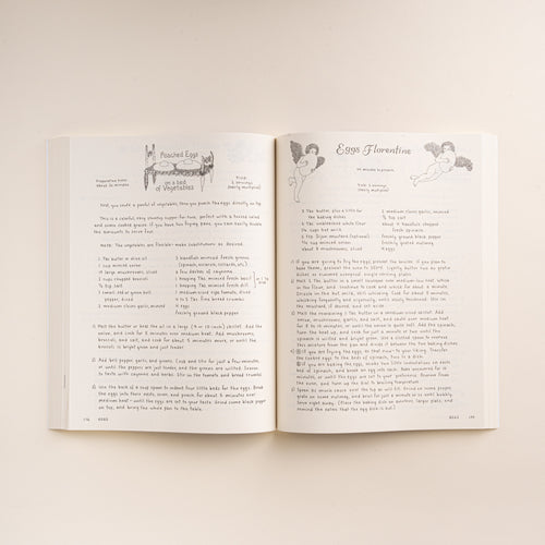 Open cookbook showing recipes for Poached Eggs on a Bed of Vegetables and Eggs Florentine.