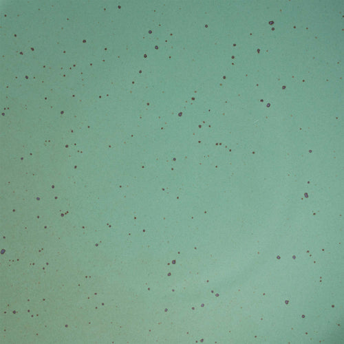 A close up of a viridian green speckled ceramic glaze