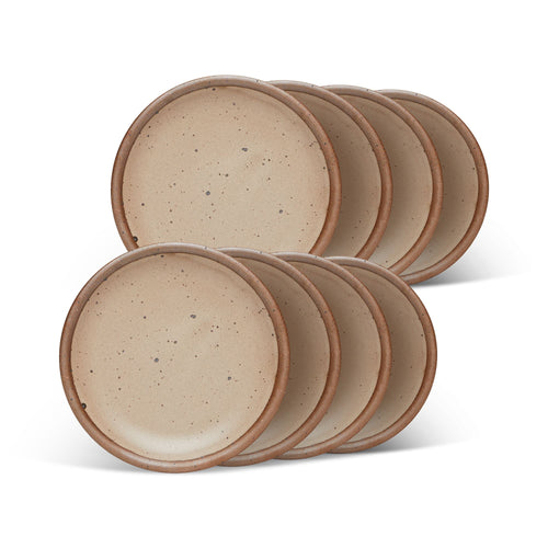 8 dessert sized ceramic plates in a warm pale brown color featuring iron speckles and an unglazed rim.
