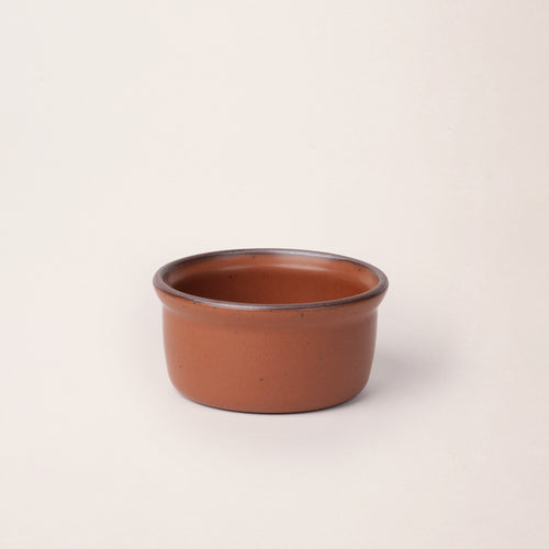 Medium ceramic ramekin in a cool terracotta color with an unglazed rim