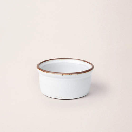 Medium ceramic ramekin in a cool white color with an unglazed rim