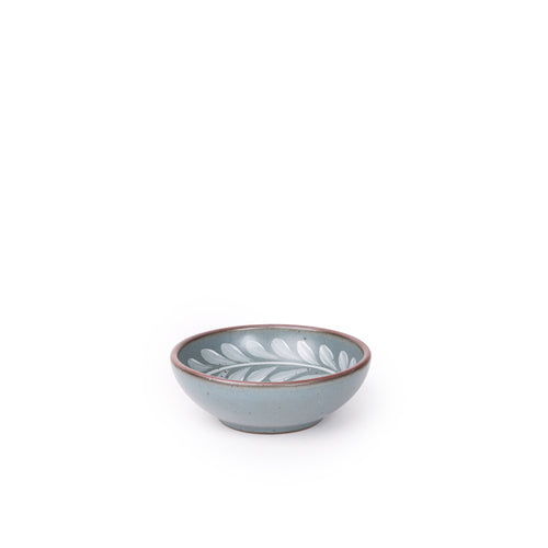 Small ceramic shallow bowl with a hand-painted white leaf border on a blue-grey interior and exterior with an exposed clay rim.