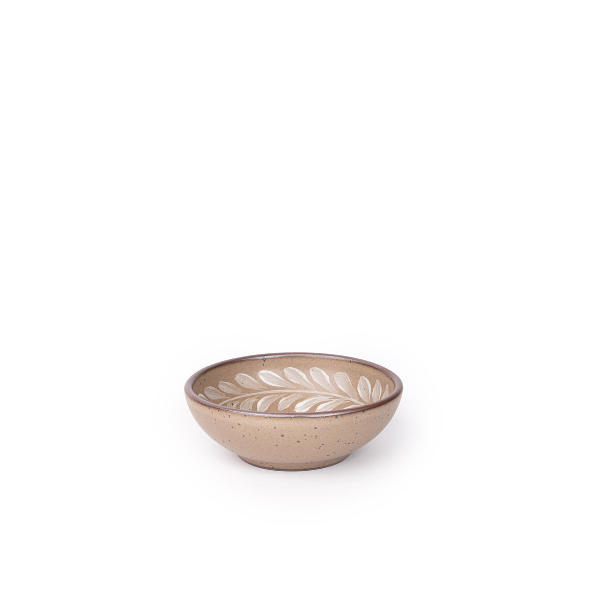 Small ceramic shallow bowl with a hand-painted white leaf border on a pale warm brown interior and exterior with an exposed clay rim.