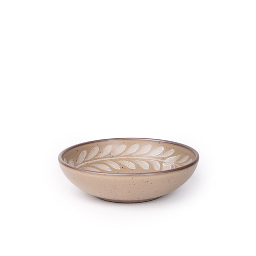 Medium ceramic shallow bowl with a hand-painted white leaf border on a pale warm brown interior and exterior with an exposed clay rim.
