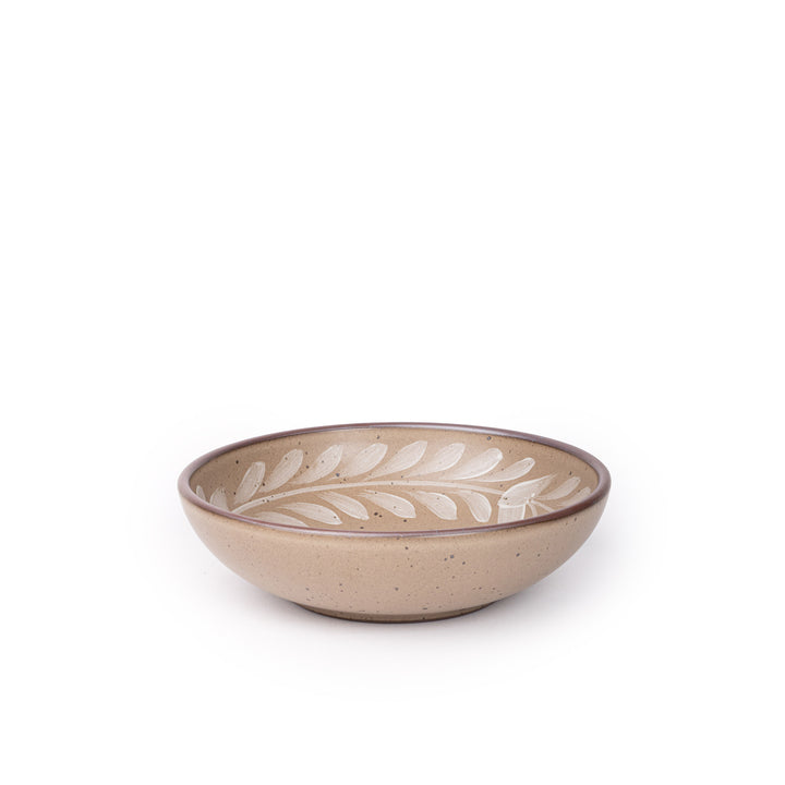 Medium ceramic shallow bowl with a hand-painted white leaf border on a pale warm brown interior and exterior with an exposed clay rim.