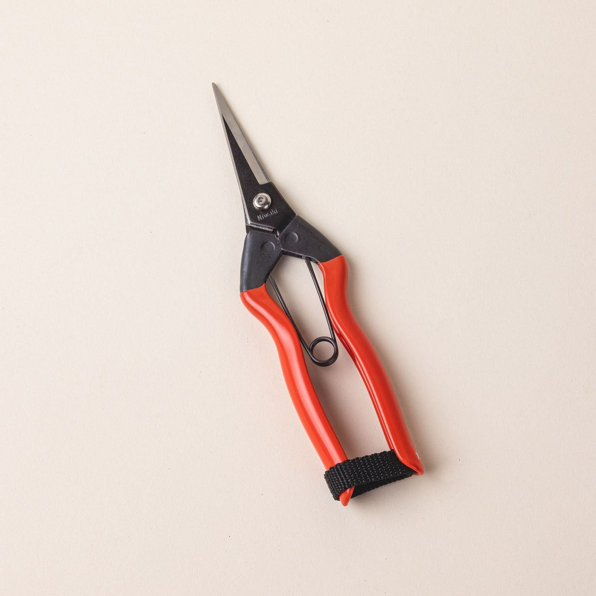 A pair of garden snips with an orange handle and narrow short blades