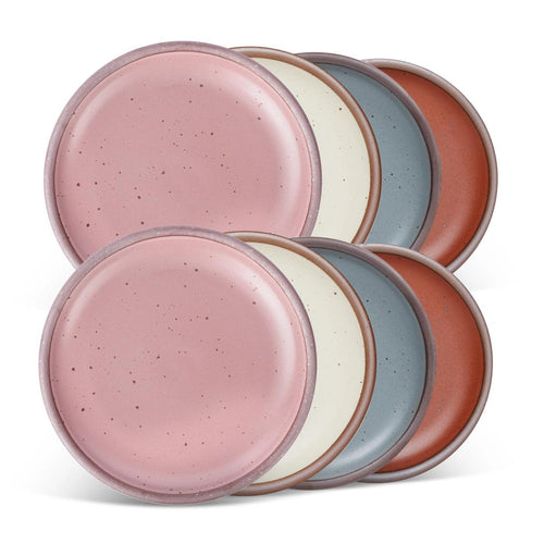 8 medium sized ceramic plates in a dusty mauve pink, blue-grey, warm off-white and cool terracotta colors featuring iron speckles and an unglazed rim.