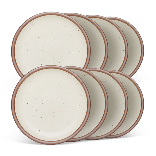 8 medium sized ceramic plates in a warm off-white color featuring iron speckles and an unglazed rim.
