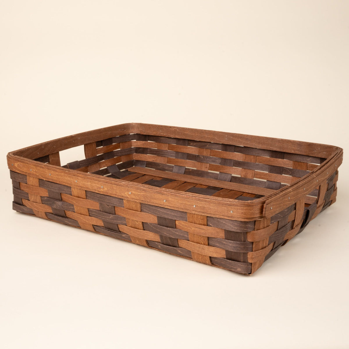 Rectangular woven wood basket in two-tone brown with an open top and reinforced rim, displayed against a neutral background.
