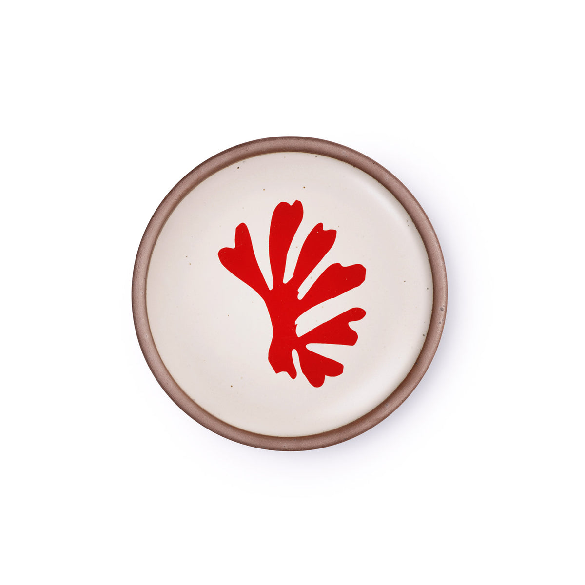 A ceramic dessert sized plates in a warm off-white color with unglazed rim, a frond-like cut-outs from Henri Matisse’s La Perruche et la sirène.