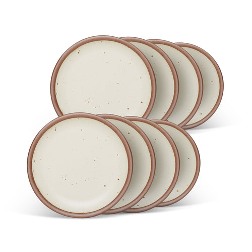 8 dessert sized ceramic plates in a warm, tan-toned, off-white color featuring iron speckles and an unglazed rim.