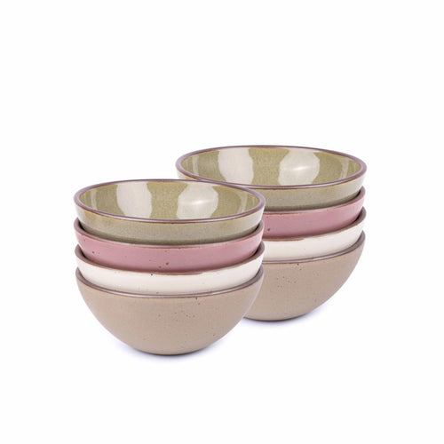 A stack of 8 medium sized rounded ceramic bowls in a reflective dappled grey-green, warm off-white, warm pale brown and dusty mauve pink colors featuring iron speckles and an unglazed rim
