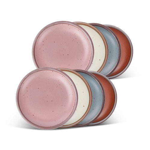 8 dessert sized ceramic plates in a cool terracotta, warm off-white, blue-grey and dusty mauve pink colors featuring iron speckles and an unglazed rim.
