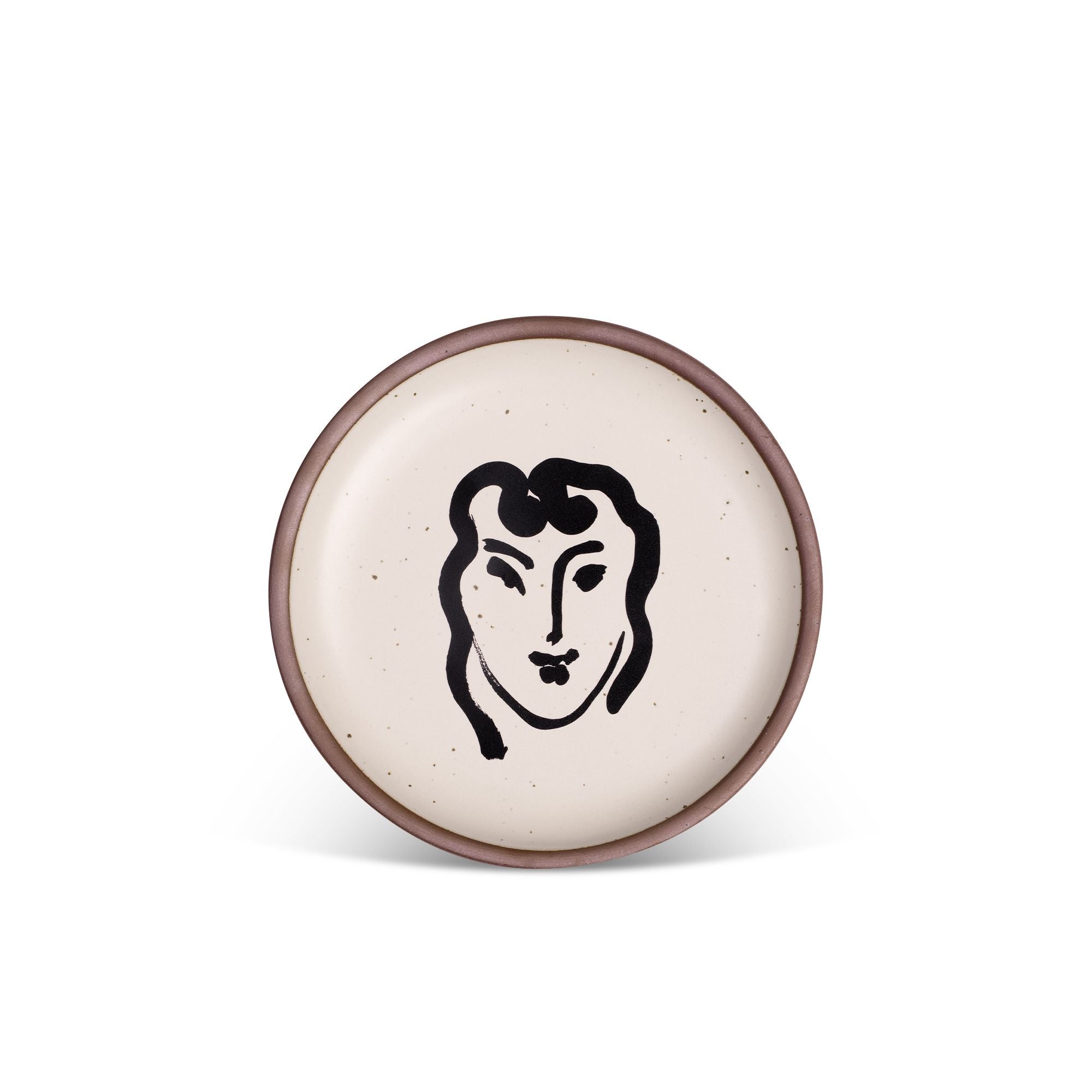 A ceramic plate featuring a decal of the artwork, Patitcha souriante, by Henri Matisse. A minimalist black ink decal of a woman's smiling face in an abstract, expressive style centered on an off-white ceramic plate with an unglazed rim.
